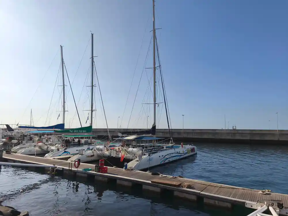 Catamarans and yachts moored along the marina pontoon