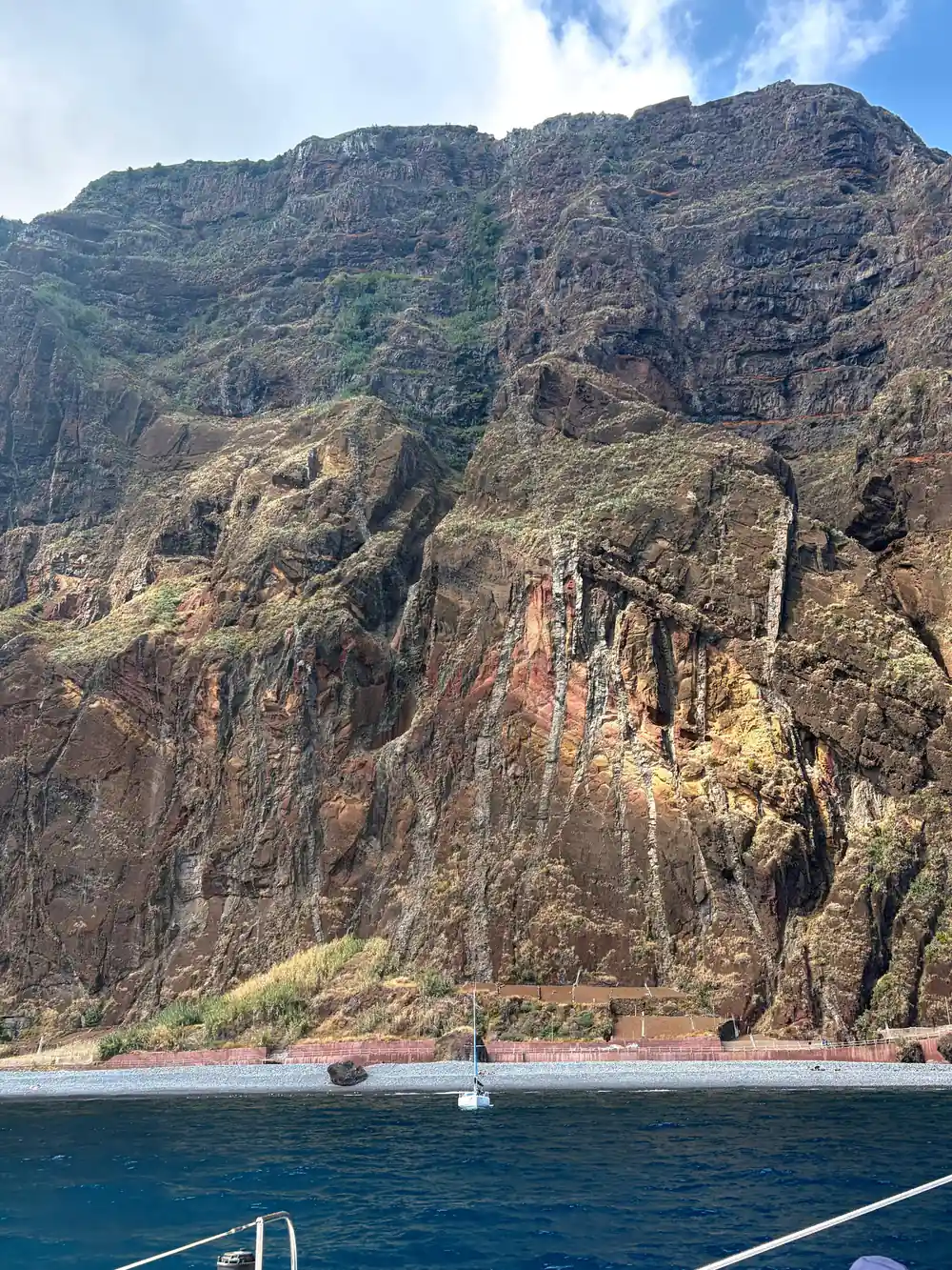 A close view of layered volcanic rock in the cliff face
