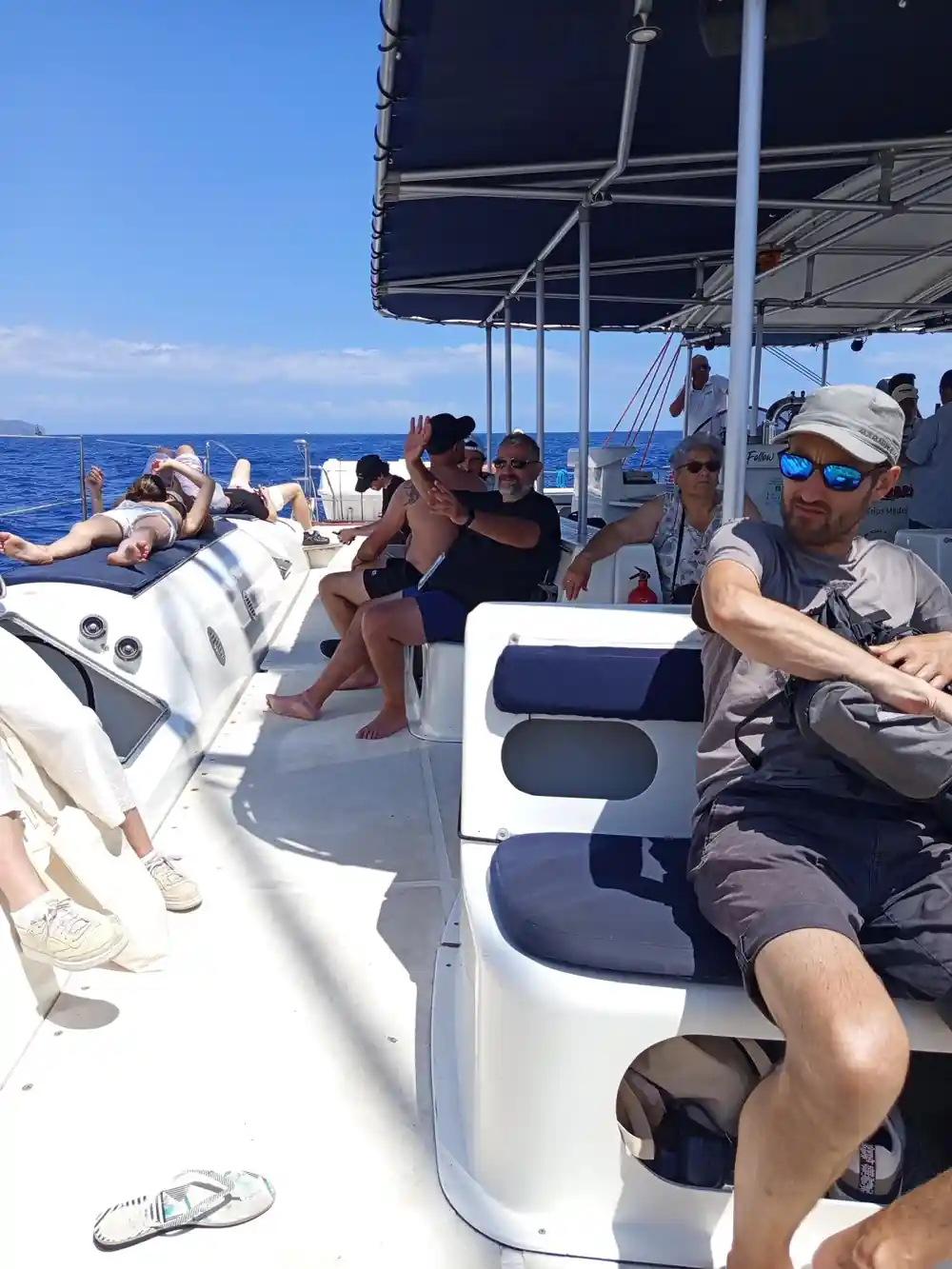 Guests and crew seated around the shaded cockpit