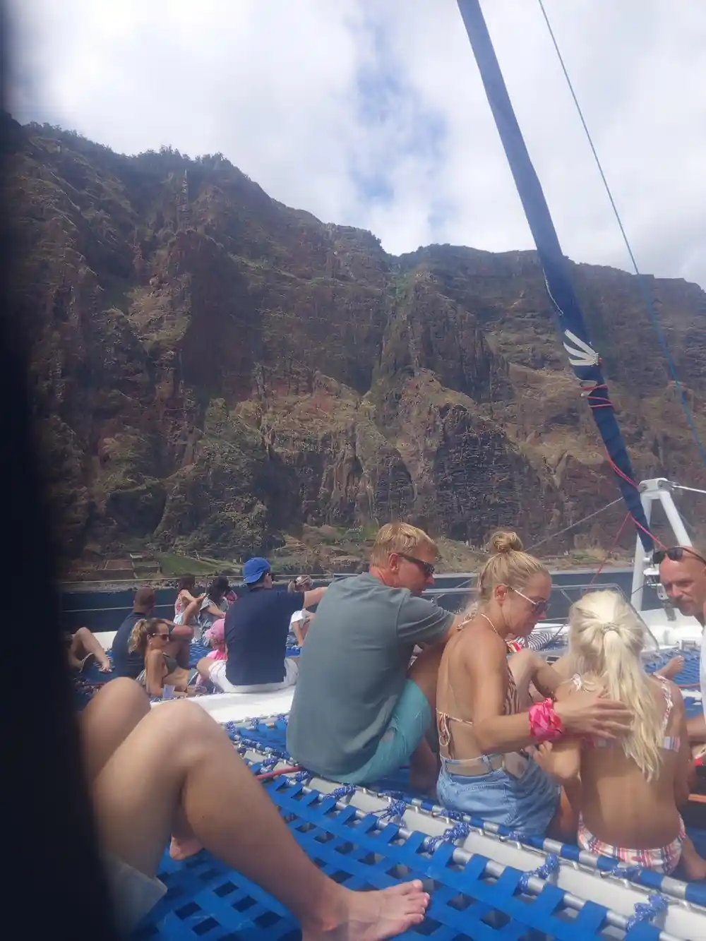 Guests on the nets with a huge cliff face behind them