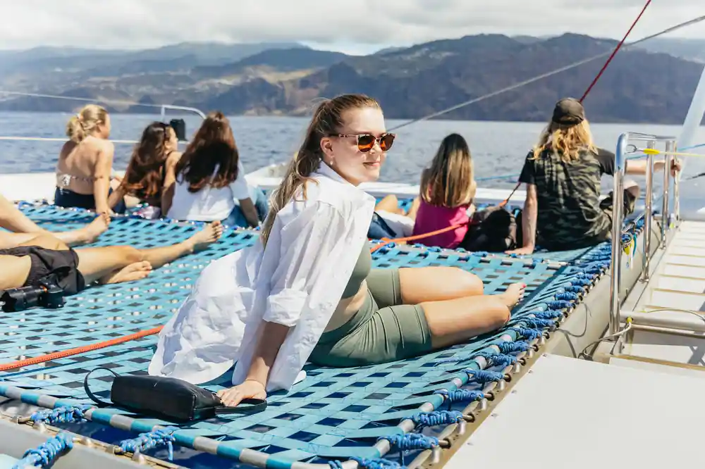 Guests relaxing on the nets with the cliffs in the distance