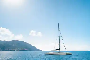 The Sea-Born catamaran full of passengers on bright turquoise water